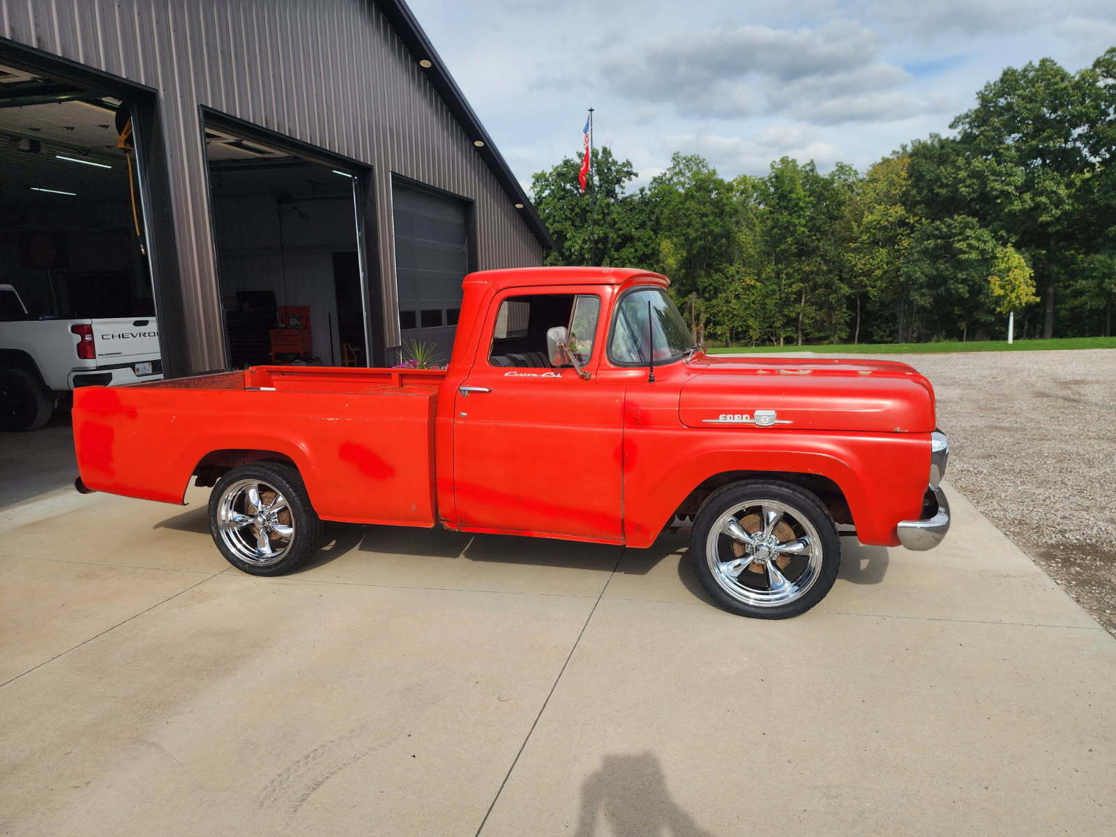 Classic Ford F100 with 20" American Racing Torq Thrust wheels and 245/45R20 Nitto NT555 G2 performance tires.
